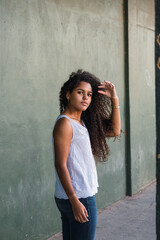Portrait of a teenage cuban woman girl from the back turning her face to the camera