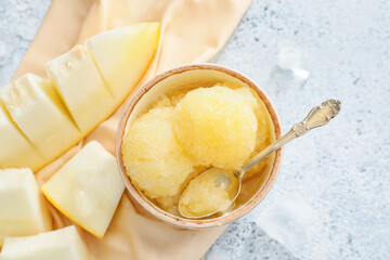 Bowl with tasty sorbet and melon on light background