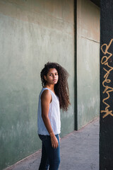 Portrait of a teenage cuban woman girl from the back turning her face to the camera