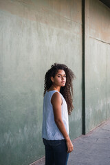 Portrait of a teenage cuban woman girl from the back turning her face to the camera