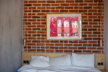 Loft style bedroom interior with red brick wall and metal lamps