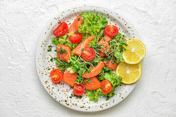 Plate with delicious salad on light background