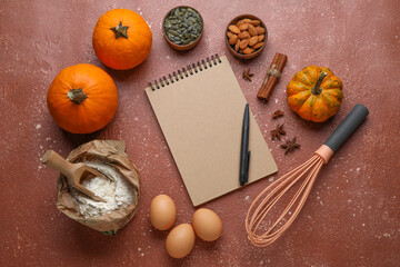 Ingredients for preparing pumpkin pie and notebook on table