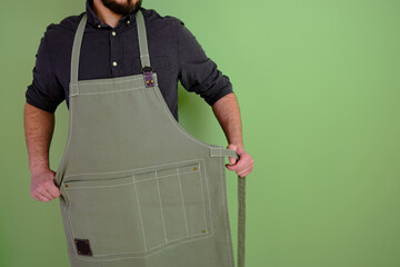 A man in a kitchen apron. Chef work in the cuisine. Cook in uniform, protection apparel. Job in...