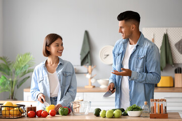 Young couple cooking in kitchen. Vegan Day