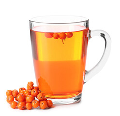 Glass cup of tasty rowan tea and berries on white background