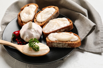 Plate of bread with lard spread on white background