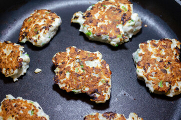 fried chicken mince patties with green on the blue iron pan top view