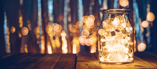 Large glass jar with light bulbs, Christmas lights and bokeh - Powered by Adobe