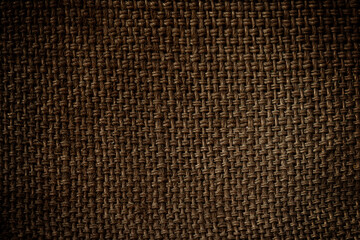 Closeup of natural sackcloth texture for background with vignette.