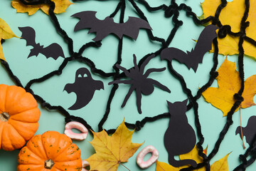 Pumpkins with candies and Halloween decor on blue background