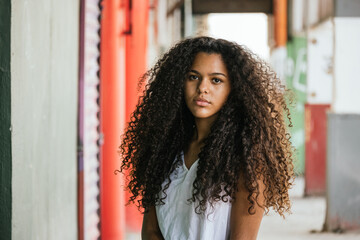 Portrait of a teenage cuban girl looking to the camera, closeup latin cuban teenage woman