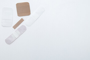 Bactericidal patches of various shapes and sizes lie on a white background with a place for text. High quality photo