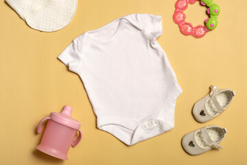 Mockup for design and placement of logos, advertising. White baby bodysuit, top view, mock up on yellow background.