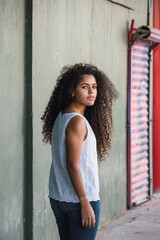 Portrait of a teenage cuban girl looking to the camera, closeup latin cuban teenage woman