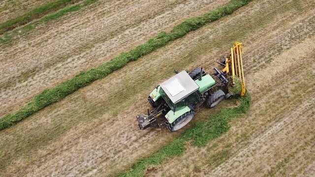 tedder machinery in action on the ground
