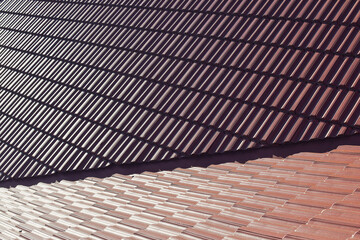 Part of the roof covered with red ceramic tiles. Selective focus. 