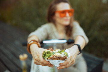 Closeup on woman and overall sitting outdoors in city