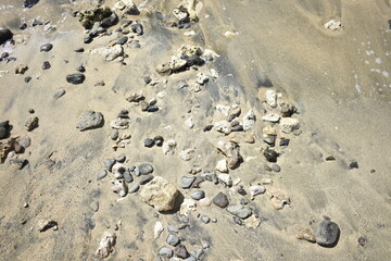 Beach rock, sand, lava water