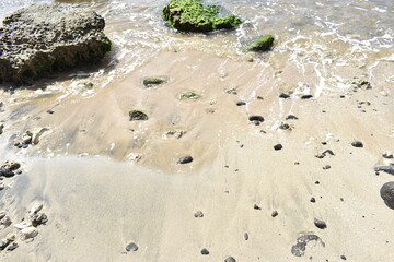 Beach rock, sand, lava water