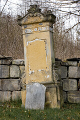 Fototapeta premium A damaged tombstone in the cemetery