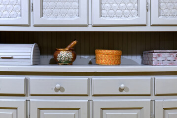 colored knacks on the top of a vintage Provencal style gray sideboard