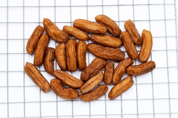 Sun-dried bananas on white background.