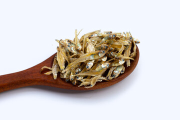 Dried anchovy in wooden spoon on white background.