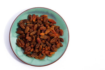 Dried grape raisins in plate on white background