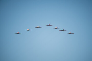 Eagle patrol in formation during the October 12 air parade for the celebration of Hispanic Day, on a sunny day with blue skies
