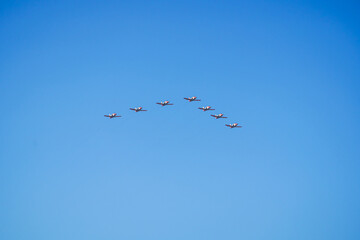 Eagle patrol in formation during the October 12 air parade for the celebration of Hispanic Day, on a sunny day with blue skies
