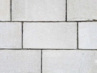 A background of white large, rough and cracked blocks that are reinforced with cement at the seams, an excellent close-up background