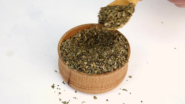 Chef taking spices Italian herbs, basil, oregano