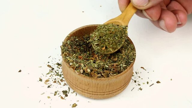 Chef taking varied spices with pepper and herbs.