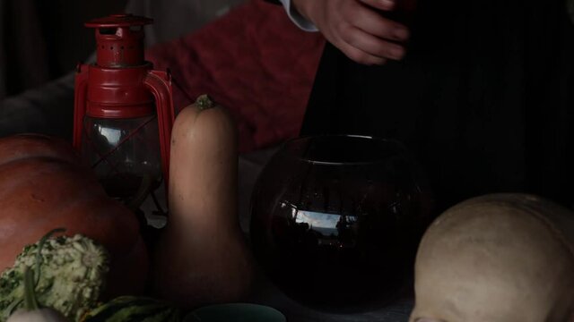 Goth witch makes magic potion for Halloween