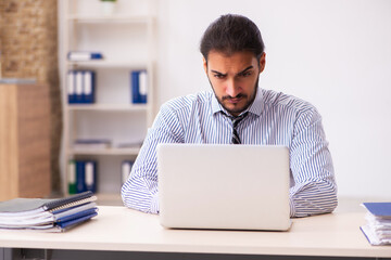 Young male employee working in the office