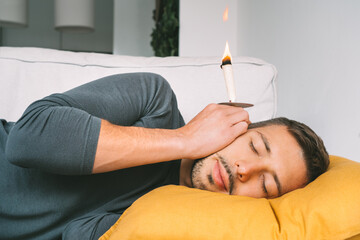 Man having ear candle treatment at home - obrazy, fototapety, plakaty