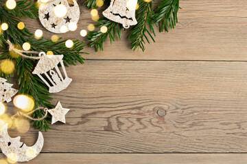 Hand made christmas decorations and christmas tree branches on a wooden table. Template for design in eco style, copy space
