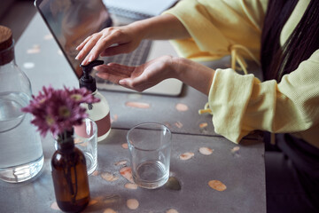 Photo of hands disinfection at cafeteria during pandemic