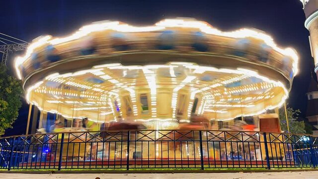 Timelapse of a brightly lit carousel at night