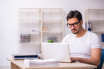 Young male student employee at workplace