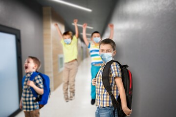 Fototapeta premium Group of cheerful children going home from school after quarantine and lockdown.