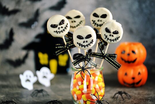 Homemade Halloween cake pops skeletons with white chocolate. Halloween sweets. 