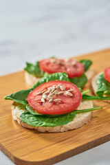 Healthy meal of rice cakes made with organic ingredients, spinach and tomato..
