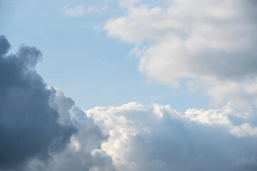 Blue sky background with white dramatic clouds and sunlight, sky background