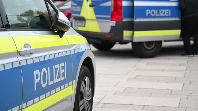 German police cars on the street. Side view of a police car with the lettering "Polizei".  Police patrol car parked on the street in Germany.


