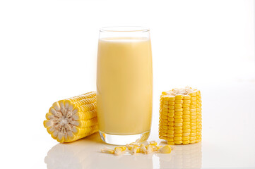 Glass of corn juice with ear corn on white background
