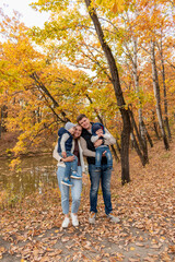 Family is resting in nature in the forest near the lake. Family member care concept. Diversity people