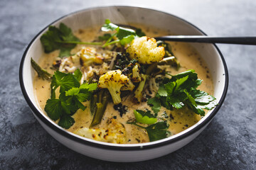 vegan cauliflower sprouts and greens soup with mustard sauce, healthy plant-based food