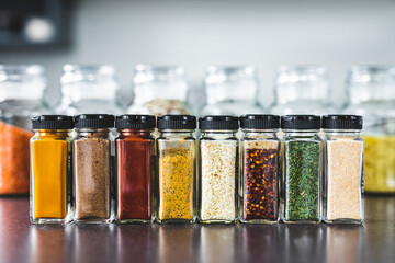 spices and grains in matching spice jars on kitchen counter, simple vegan ingredients and seasonings - obrazy, fototapety, plakaty